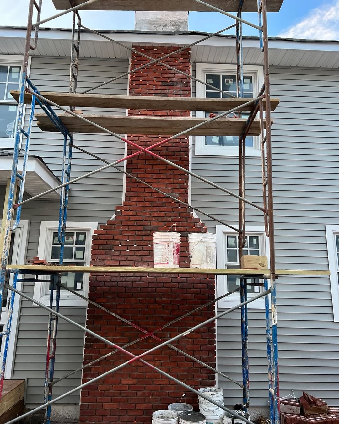 Brick chimney being rebuilt