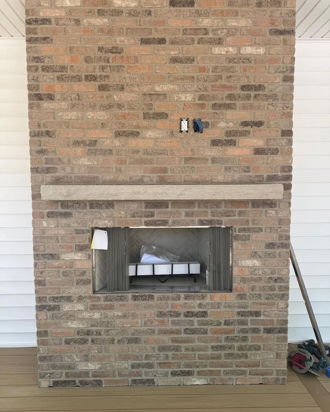 Outdoor brick fireplace with mantel
